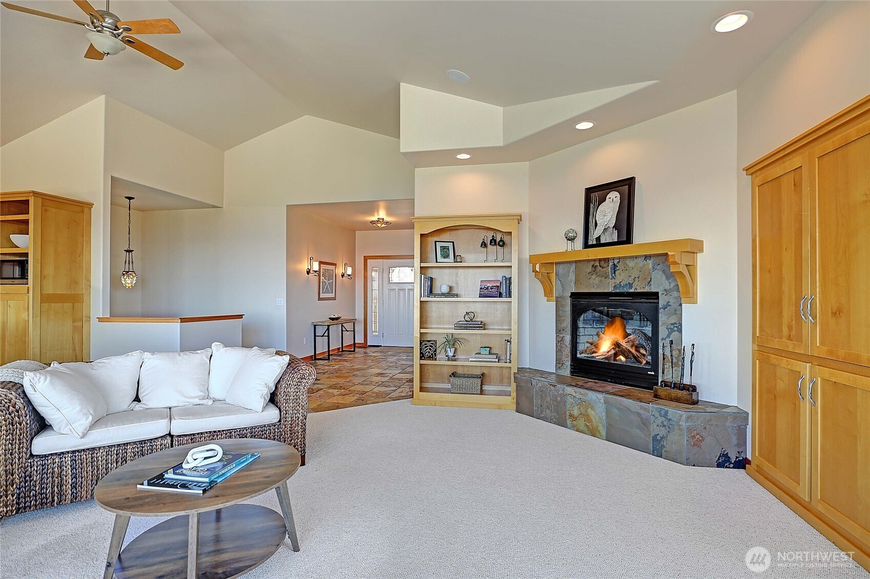 1081 Morgan Way Camano Island, WA 98282 - Photo 9 of 39 a living room with furniture a flat screen tv and a fireplace
