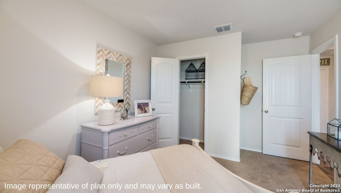 14671 Clay Rdg Run San Antonio, TX 78253 - Photo 18 of 42 a bedroom with a bed and a table in it