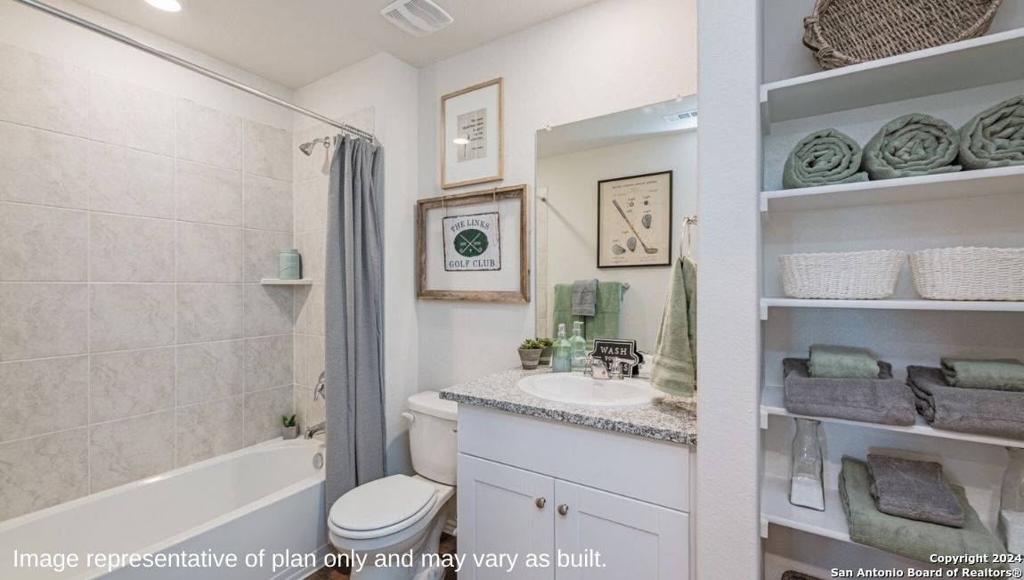 14671 Clay Rdg Run San Antonio, TX 78253 - Photo 19 of 42 a bathroom with a granite countertop sink toilet a mirror a bathtub and shower