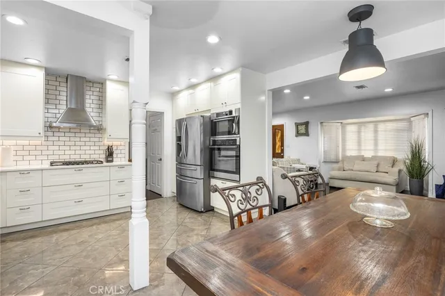 a large room with chandelier fan and windows
