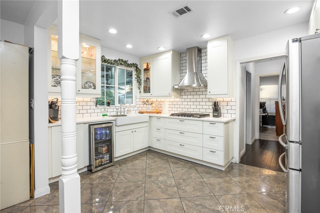 1231 South Baker Street Santa Ana, CA 92707 - Photo 13 of 48 a room with kitchen island a sink and a stove top oven