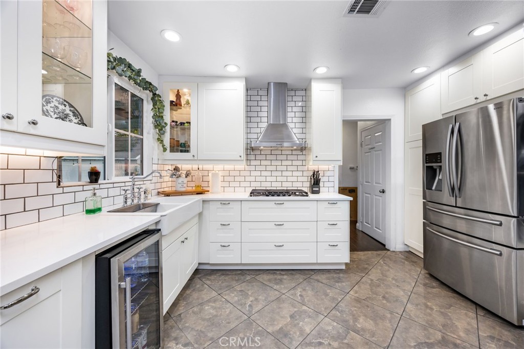 1231 South Baker Street Santa Ana, CA 92707 - Photo 14 of 48 a kitchen with a sink stove and refrigerator