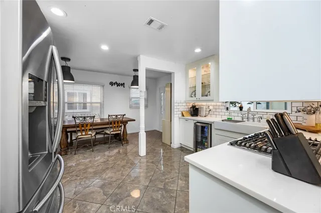 a kitchen with refrigerator and cabinets