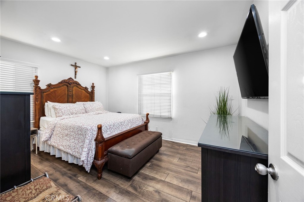 1231 South Baker Street Santa Ana, CA 92707 - Photo 17 of 48 a bedroom with a bed furniture and a flat screen tv