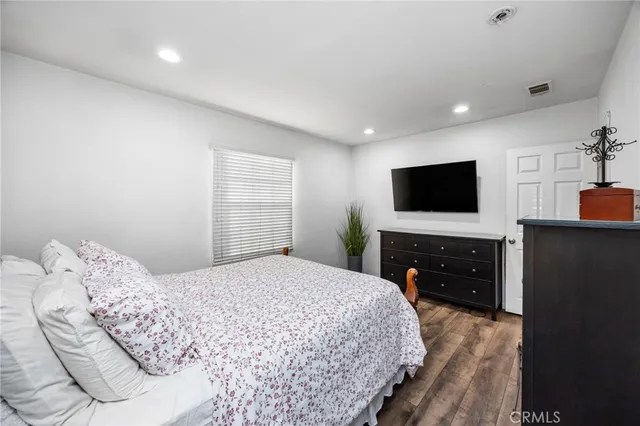 a bedroom with a bed and a flat screen tv