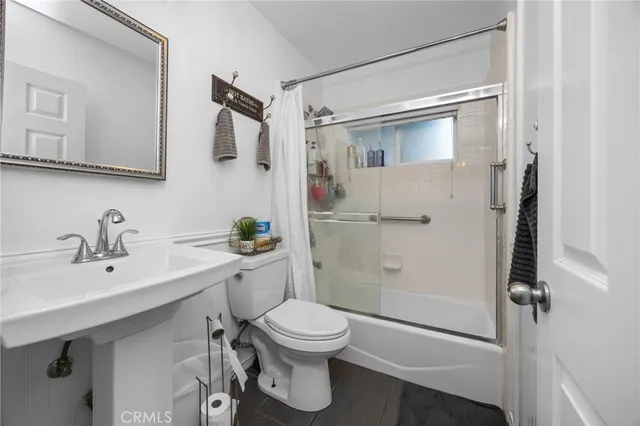 a bathroom with a toilet sink and shower