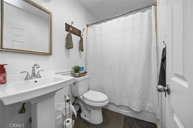 a bathroom with a toilet sink and mirror