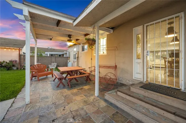 a view of a patio with table and chairs with wooden fence