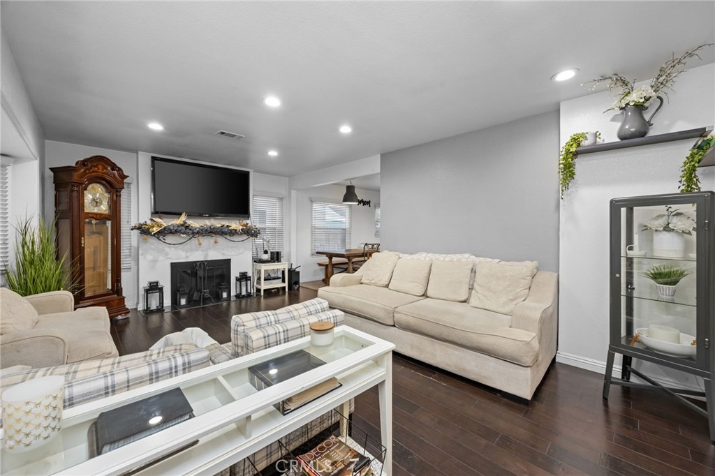 1231 South Baker Street Santa Ana, CA 92707 - Photo 4 of 48 a living room with furniture a fireplace and a flat screen tv