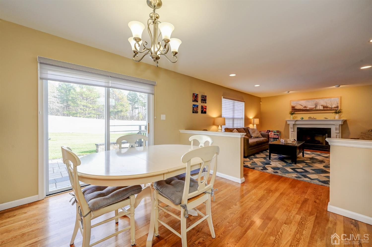 67 Gate Lane Old Bridge, NJ 08857 - Photo 13 of 39 a view of a dining room with furniture a chandelier and wooden floor