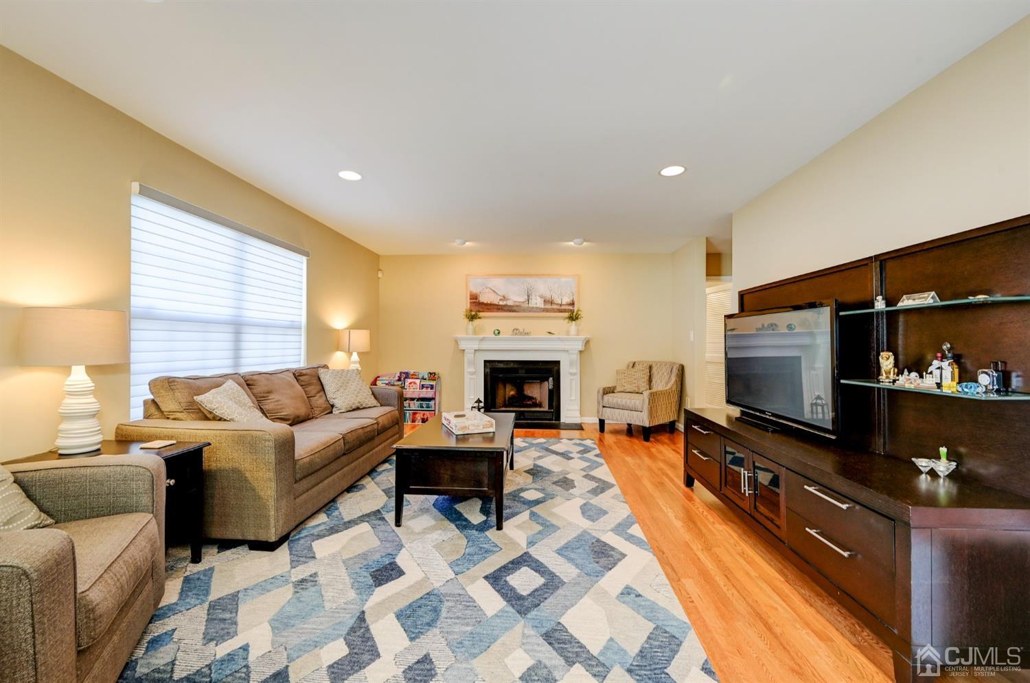67 Gate Lane Old Bridge, NJ 08857 - Photo 14 of 39 a living room with furniture a flat screen tv and a fireplace