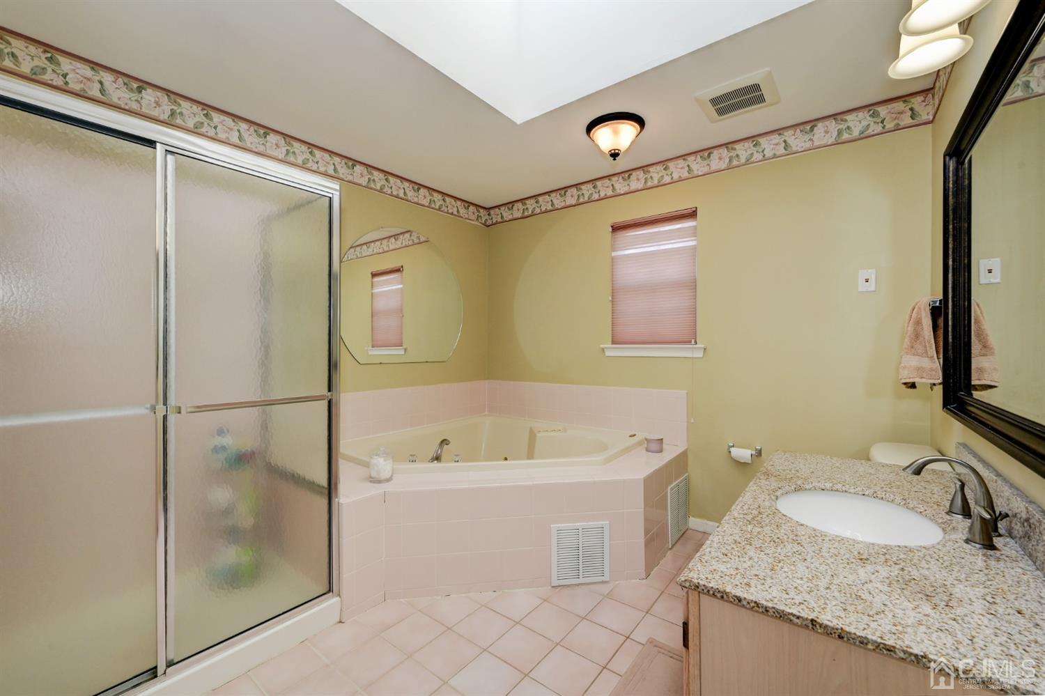 67 Gate Lane Old Bridge, NJ 08857 - Photo 18 of 39 a bathroom with a granite countertop sink mirror and a bathtub