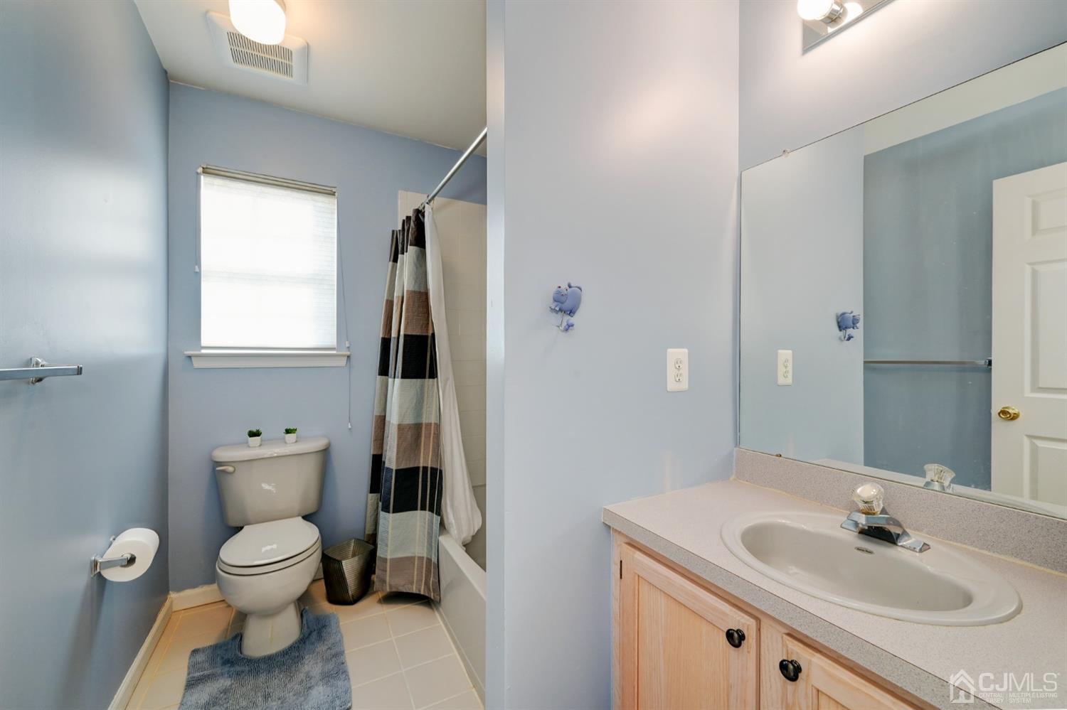 67 Gate Lane Old Bridge, NJ 08857 - Photo 22 of 39 a bathroom with a toilet a sink and mirror
