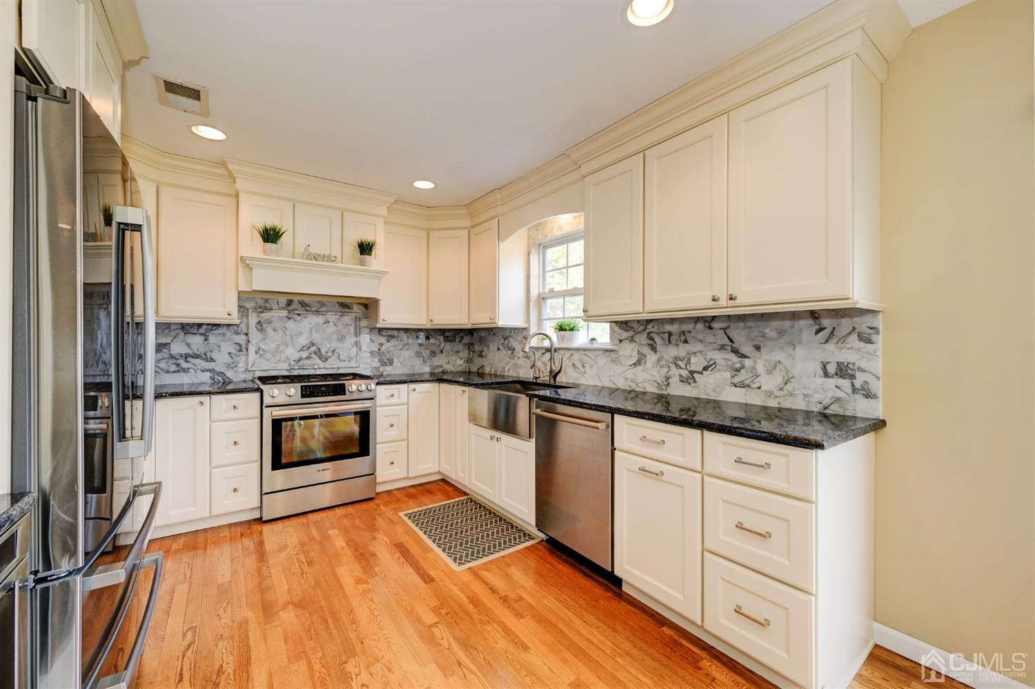 67 Gate Lane Old Bridge, NJ 08857 - Photo 10 of 39 a kitchen with granite countertop white cabinets and white appliances