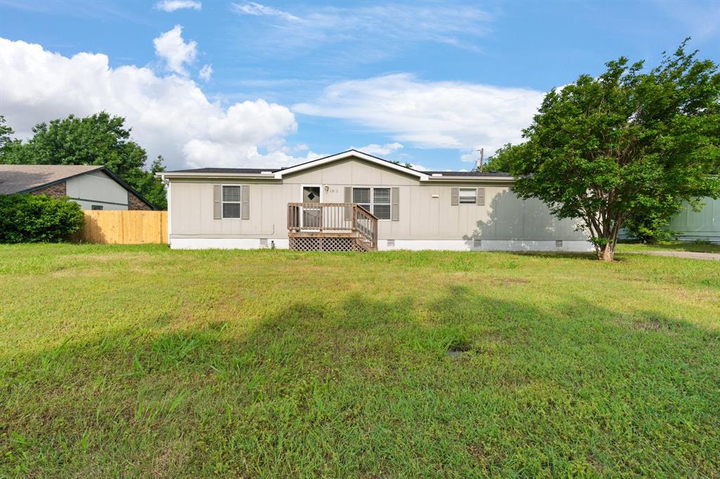 a big house with a big yard and large trees