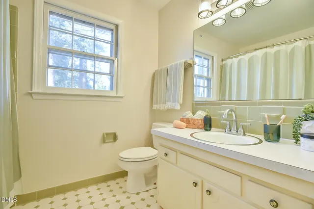 a bedroom with a bed couch and a window