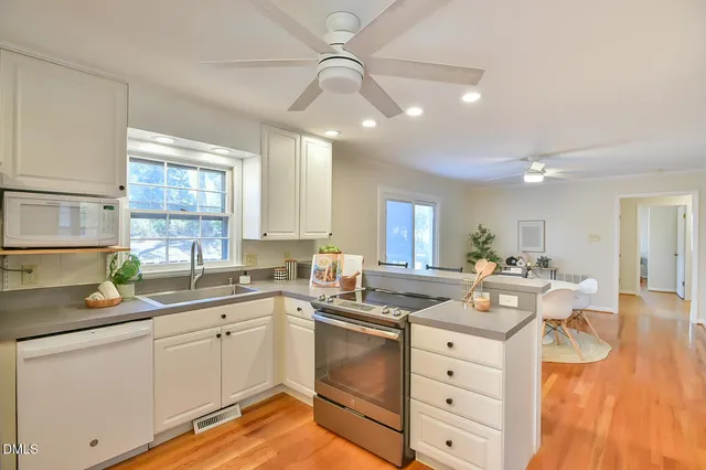 a kitchen with a sink a stove a refrigerator and a refrigerator