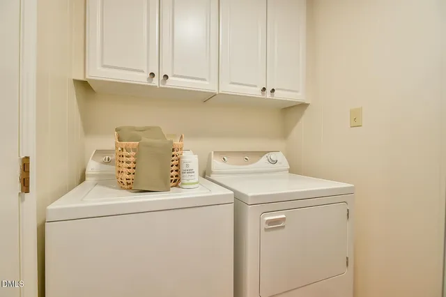 a kitchen with a sink stove cabinets and wooden floor
