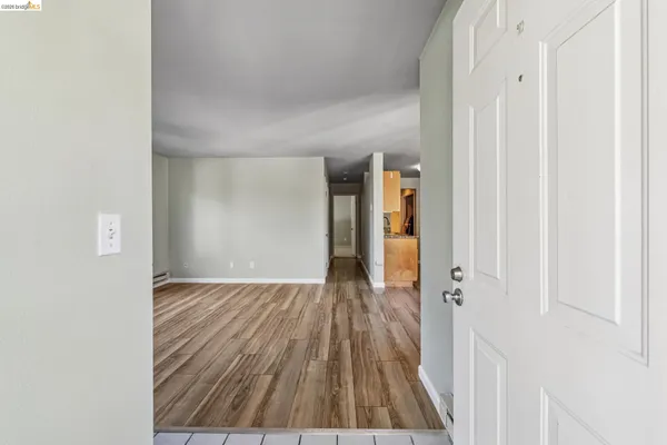 a view of a hallway with wooden floor