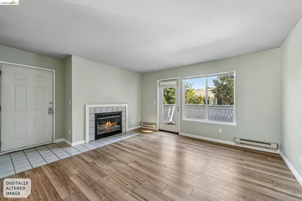 a view of an empty room with a window and fireplace