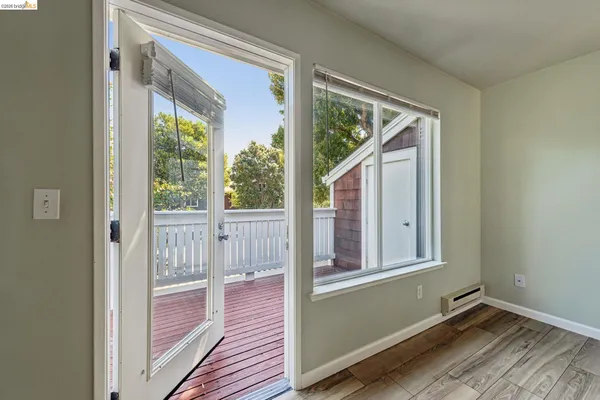 a view of a room with wooden floor and windows