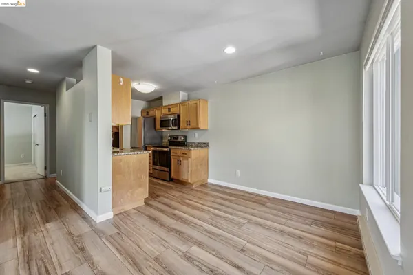 a view of kitchen view wooden floor and electronic appliances