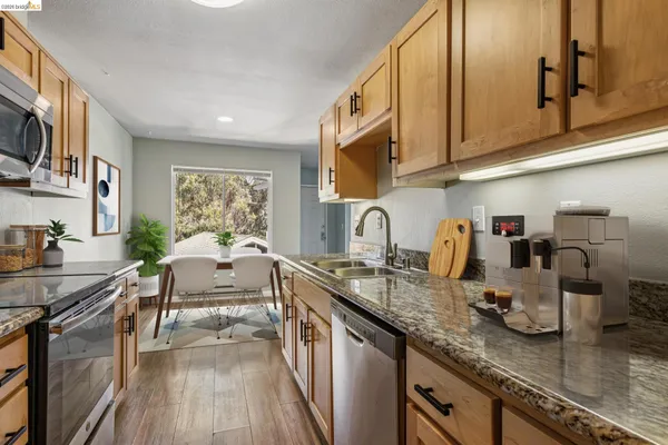 a kitchen with sink a stove and cabinets