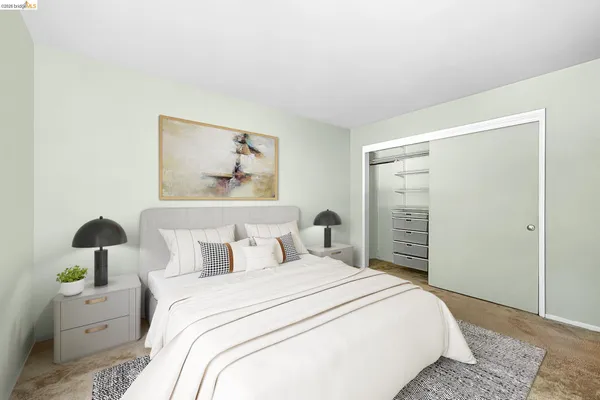 a bedroom with a bed and a painting on the wall