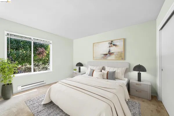 a bedroom with a bed and a large window