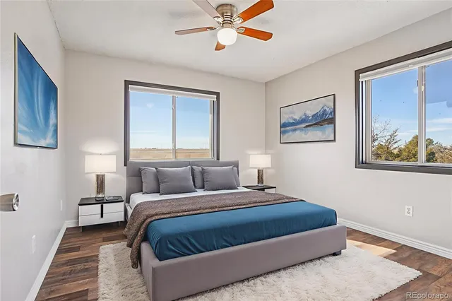 a bedroom with a bed and painting on the wall