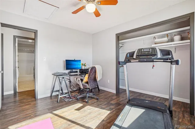 a workspace with wooden floor and windows