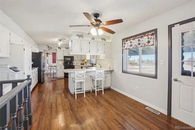 a dining room with wooden floor and a window