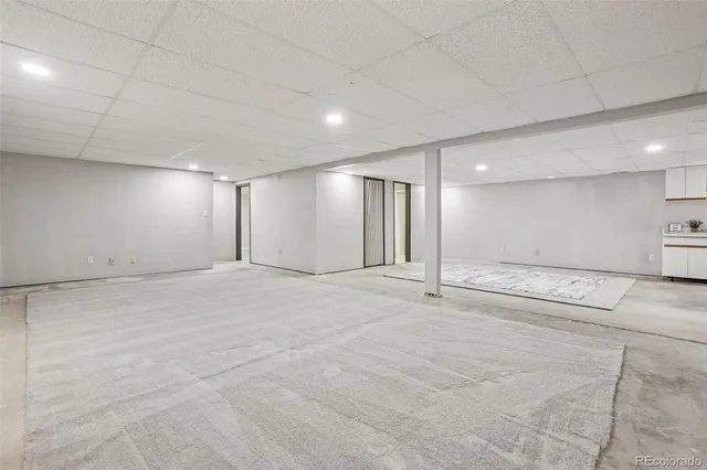 a bedroom with a large bed and a potted plant