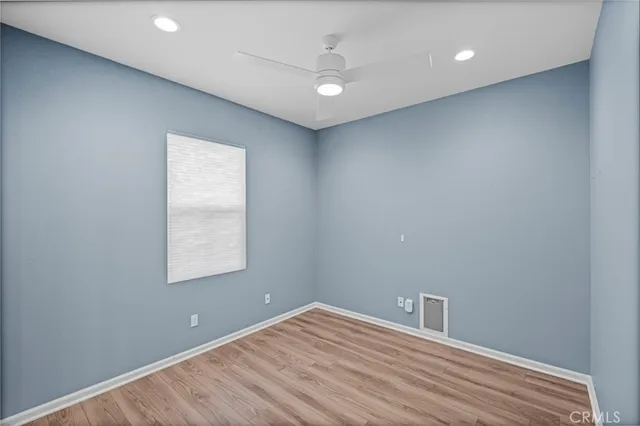 a bedroom with a large bed and a flat screen tv