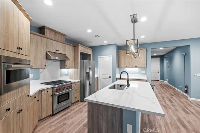 a kitchen with a refrigerator and a stove