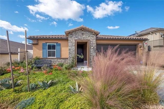 a front view of a house with garden