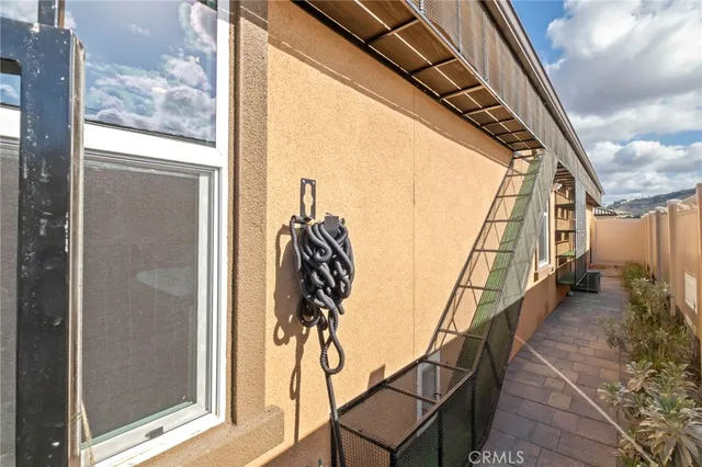 a front view of a house with a yard and mountain view in back