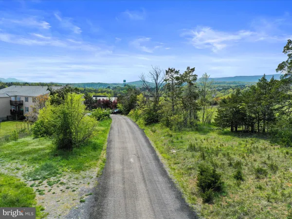 a view of a pathway both side of house