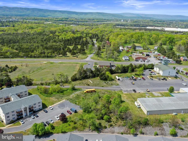 an aerial view of residential houses with outdoor space and swimming pool
