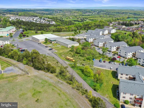 an aerial view of residential houses with outdoor space and street view