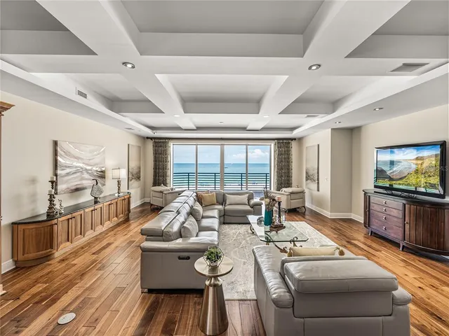 a bedroom with a large bed rug and wooden floor