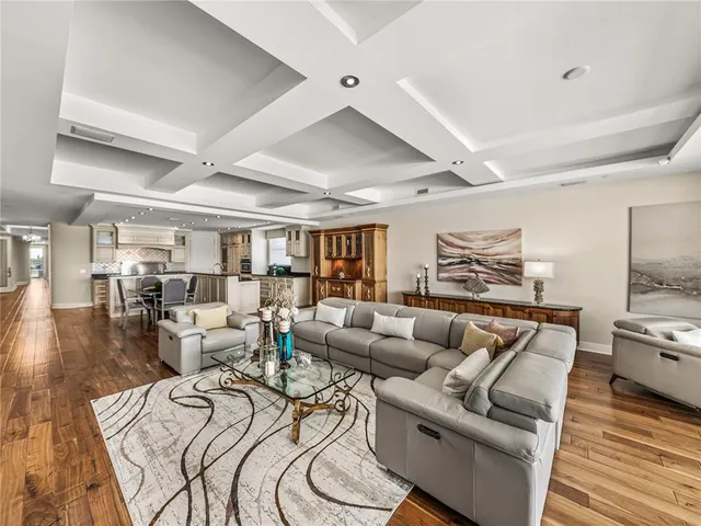 a large white bathroom with a granite countertop sink mirror and toilet