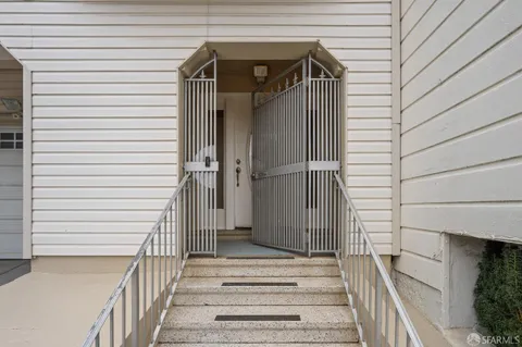 a view of a hallway with furniture and staircase