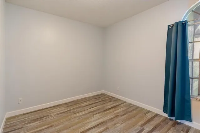 a view of a room with wooden floor