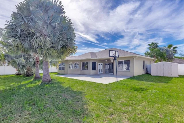 a view of a house with a yard and sitting area