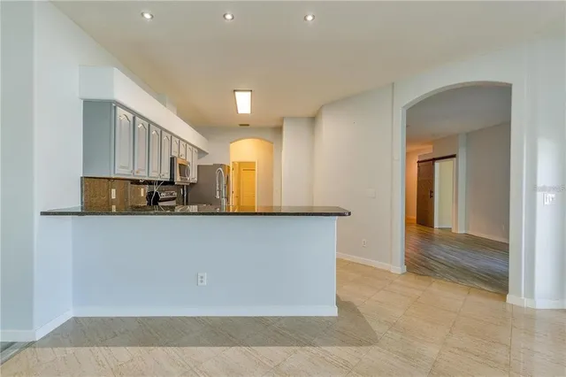 a view of kitchen with cabinets