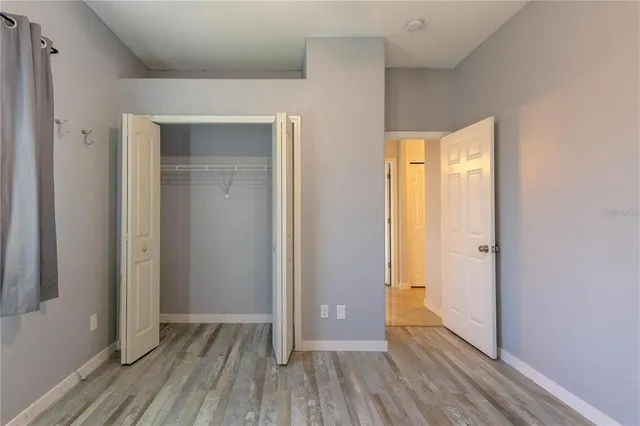 a view of hallway with wooden floor