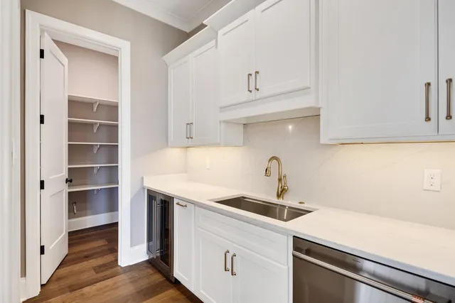 a large kitchen with kitchen island a sink a center island a stove and a window