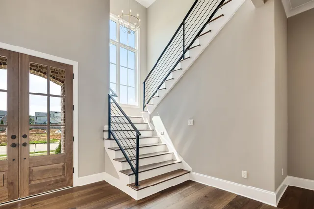 a spacious bathroom with a double vanity sink large mirror and a bathtub