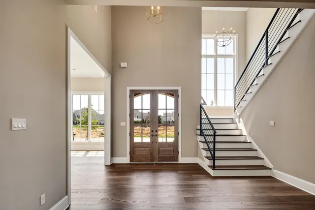 a view of entryway and hall with wooden floor